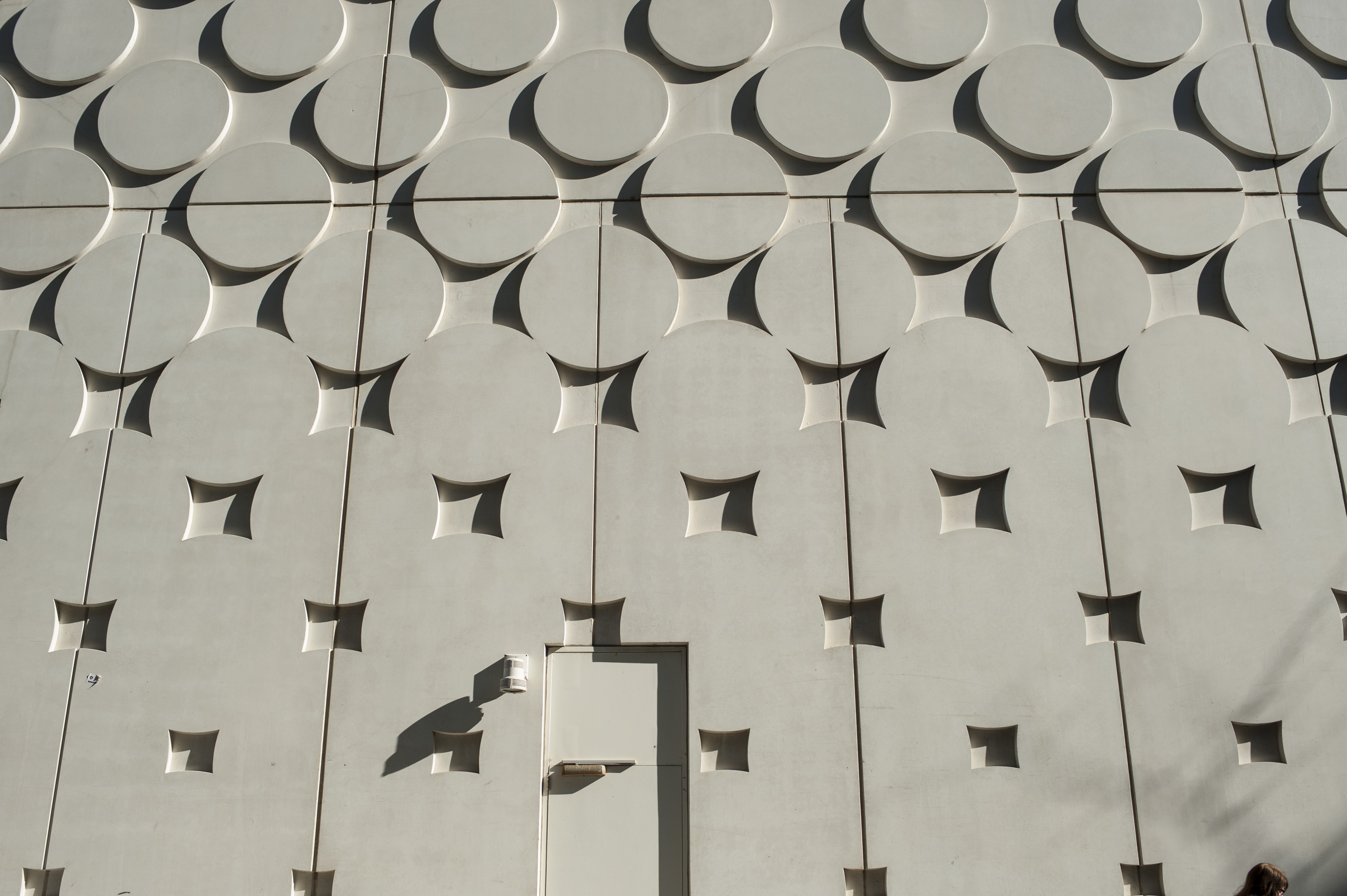 Image of ATC building wall with an indented circle patter