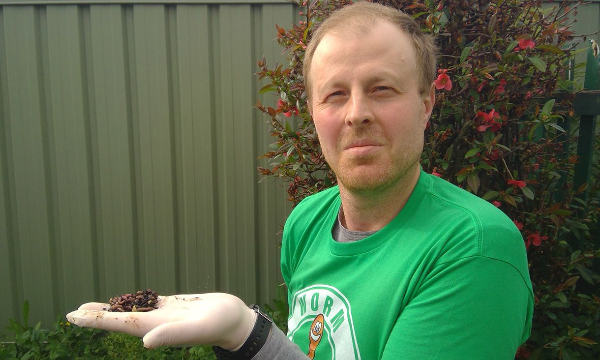Ivan Maksimov wearing a green tshirt holding a handful of earthworms