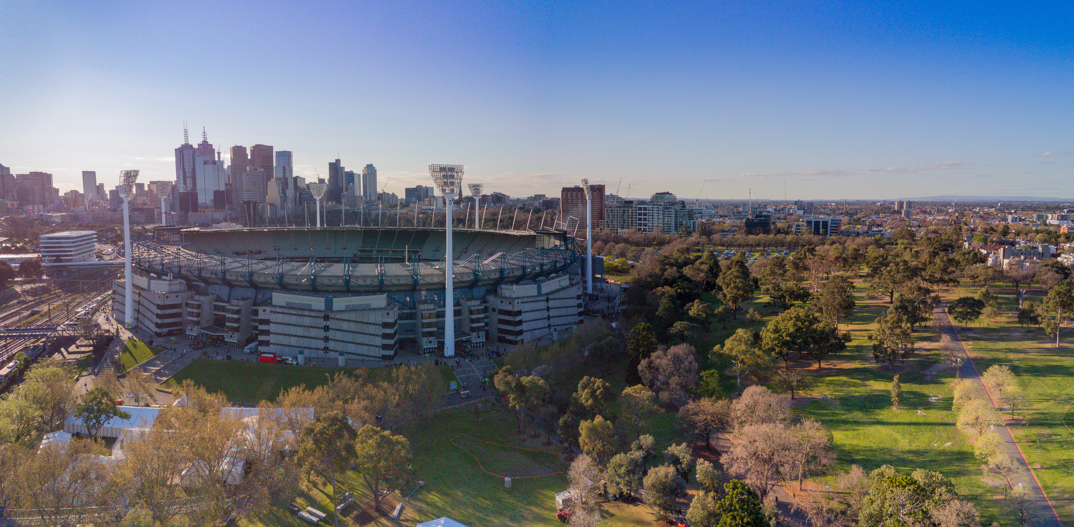 Aerial shot of the Melbourne Cricket Ground with Melbourne city skyline behind