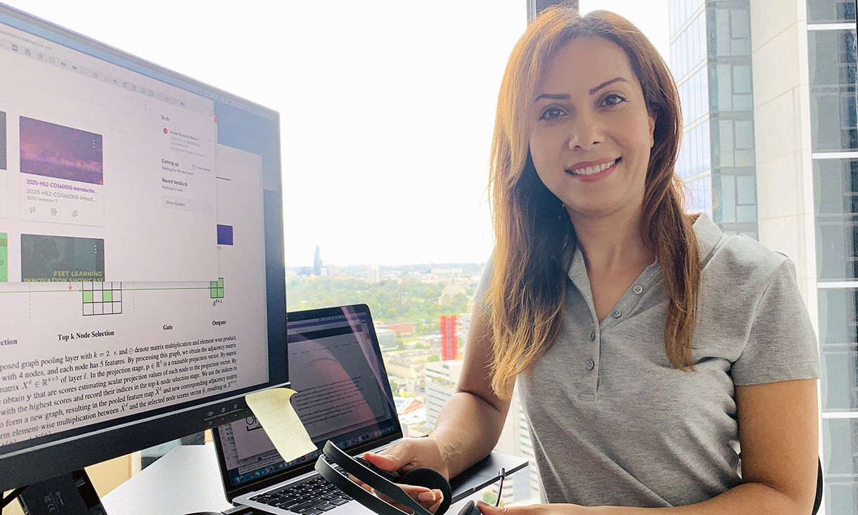 Dr Dana Rezazadegan seated at her computer