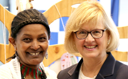Male Swinburne employee wearing red t-shirt with Swinburne logo