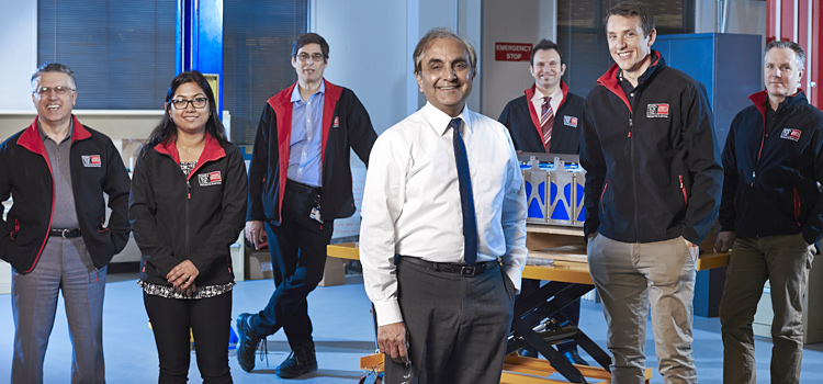 Professor Ajay Kapoor with members of the Electric Vehicle Lab research group
