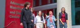 A group of students walking together on Swinburne's Hawthorn campus. The group are young adults, with a mix of male and female from diverse backgrounds.