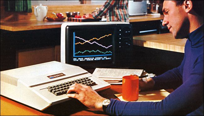 Old photo of man creating charts and graphs on his Apple Two computer