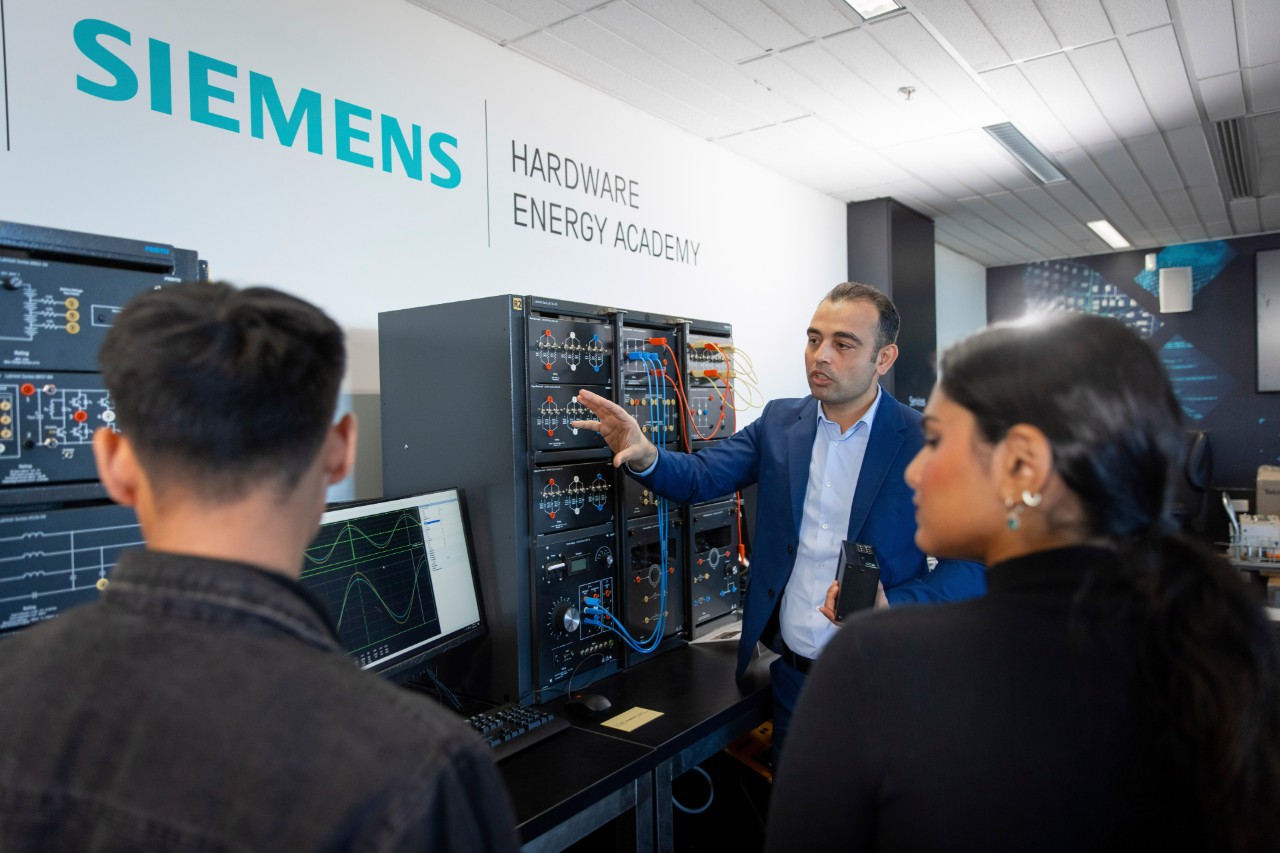 Students being shown Festo LabVolt electrical hardware by a teacher