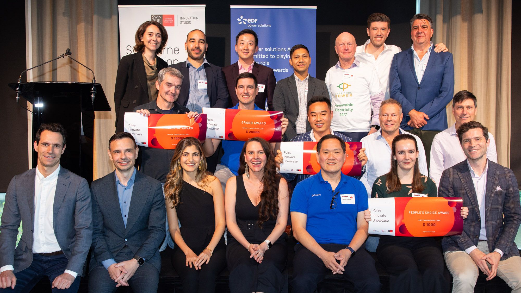 Group of award winners holding up certificates.