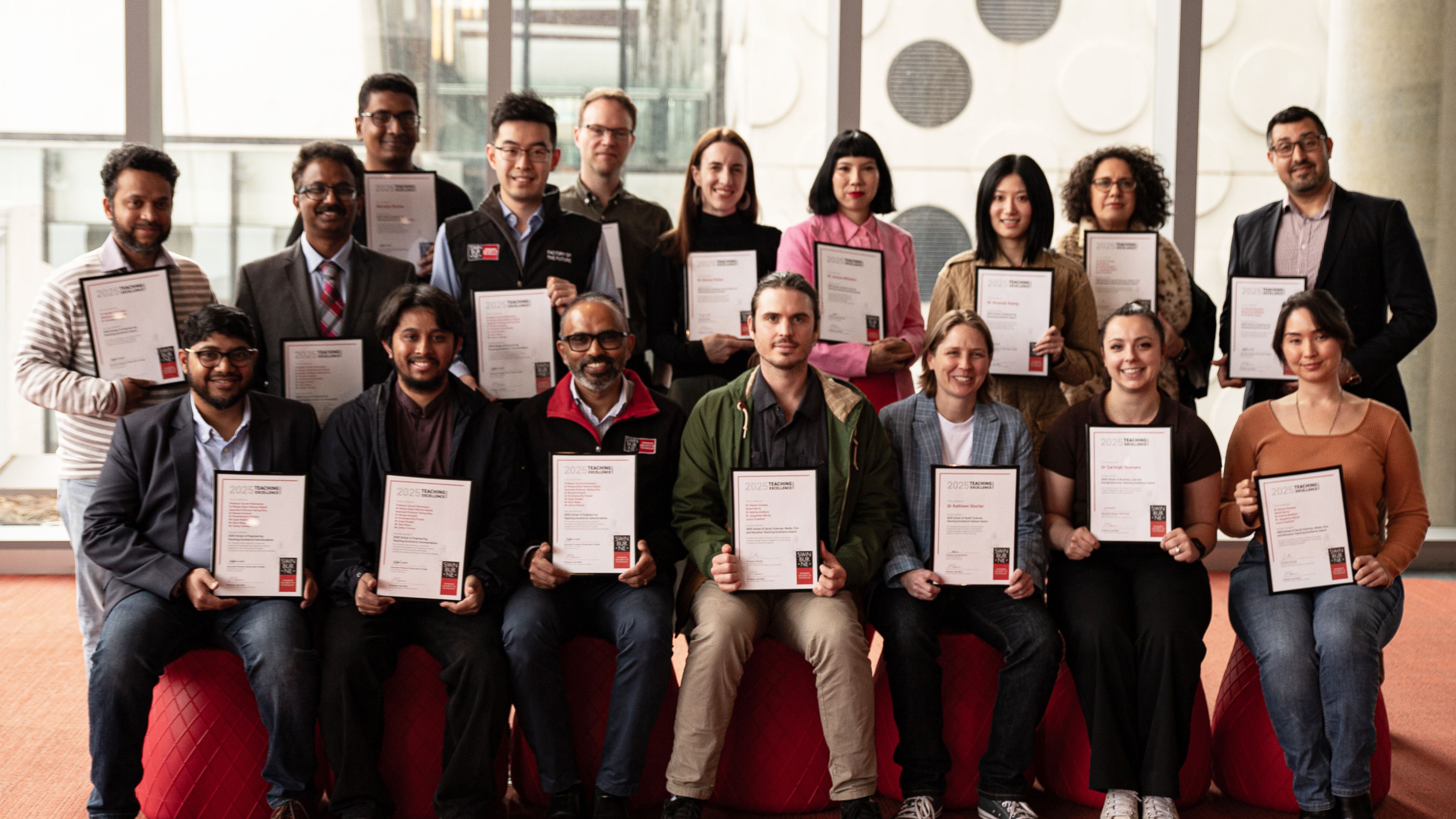 Group shot of award winners holding certificates.