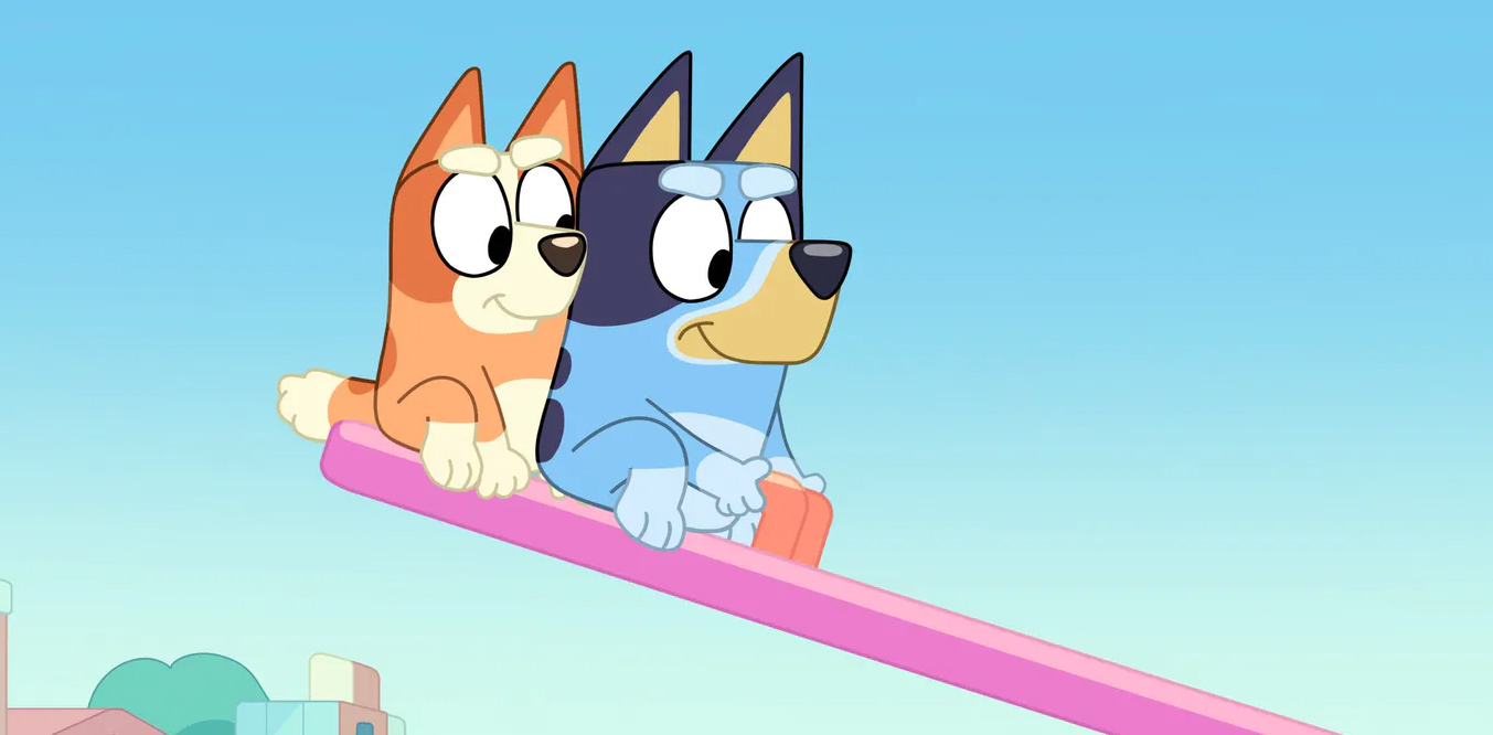 Two characters from the Australian kid's show, Bluey playing on a seesaw