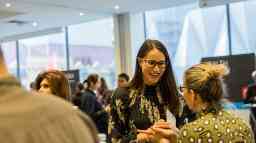 Two ladies talking at a Swinburne course advice event