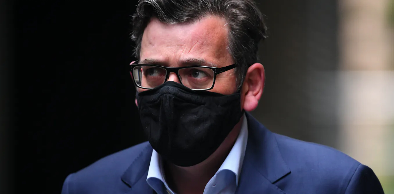 Victorian Premier Dan Andrews wearing a black facemask and blue suit