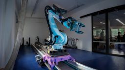 blue and purple industrial robot arm