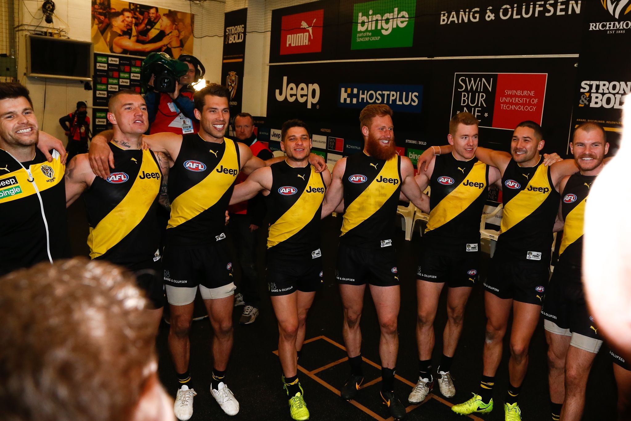 The Richmond Tigers AFL team stand in circle and sing club song in the wake of a victory