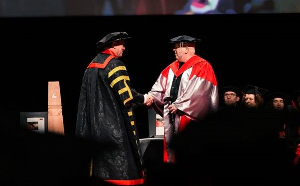 Chancellor Professor John Pollaers shaking hands with Simon Hammond at August graduation ceremony