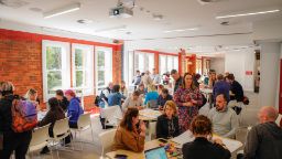 Students and staff sitting at tables