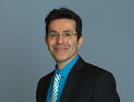 Distinguished Professor Saeid Nahavandi smiling in a suit and tie.