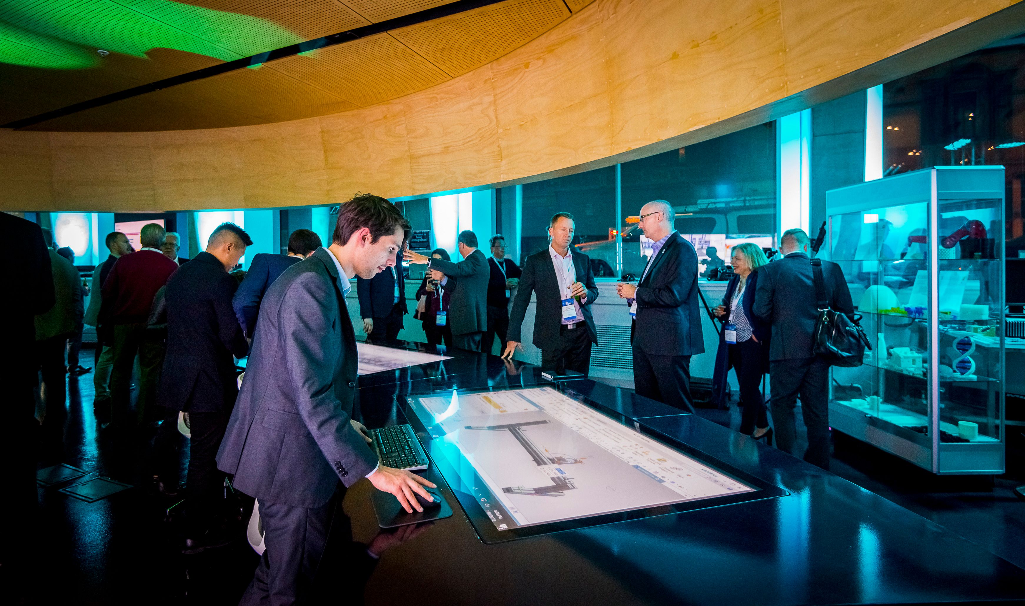 Swinburne graduate Callan Halton, operating a touch screen showing a Siemens factory simulation at the MindSphere launch event 