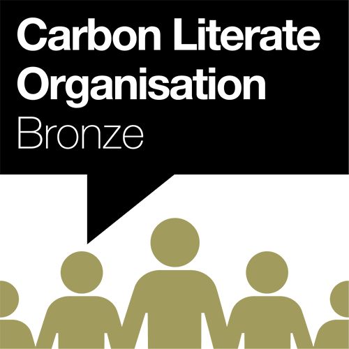 Carbon Literate Organisation Bronze text in black speech bubble with 5 gold people graphics.