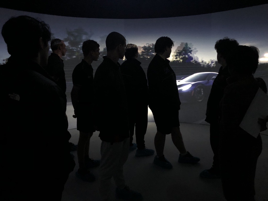 Students stand in the 360 degree viewing room called ‘Igloo’ at KIOSC, which shows a car.
