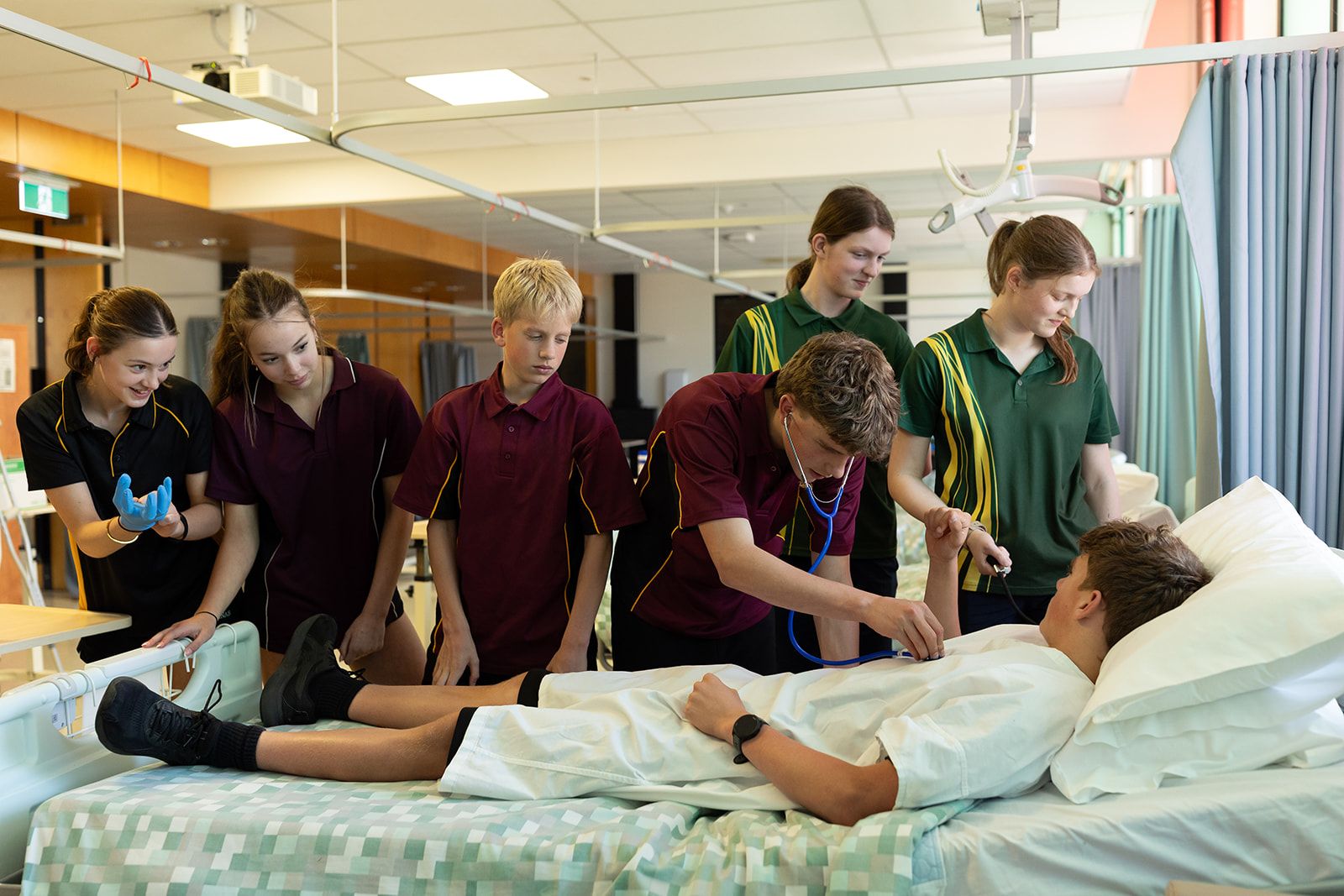 Swinburne Future Students -Students gathered around a hospital bed taking care of a patient
