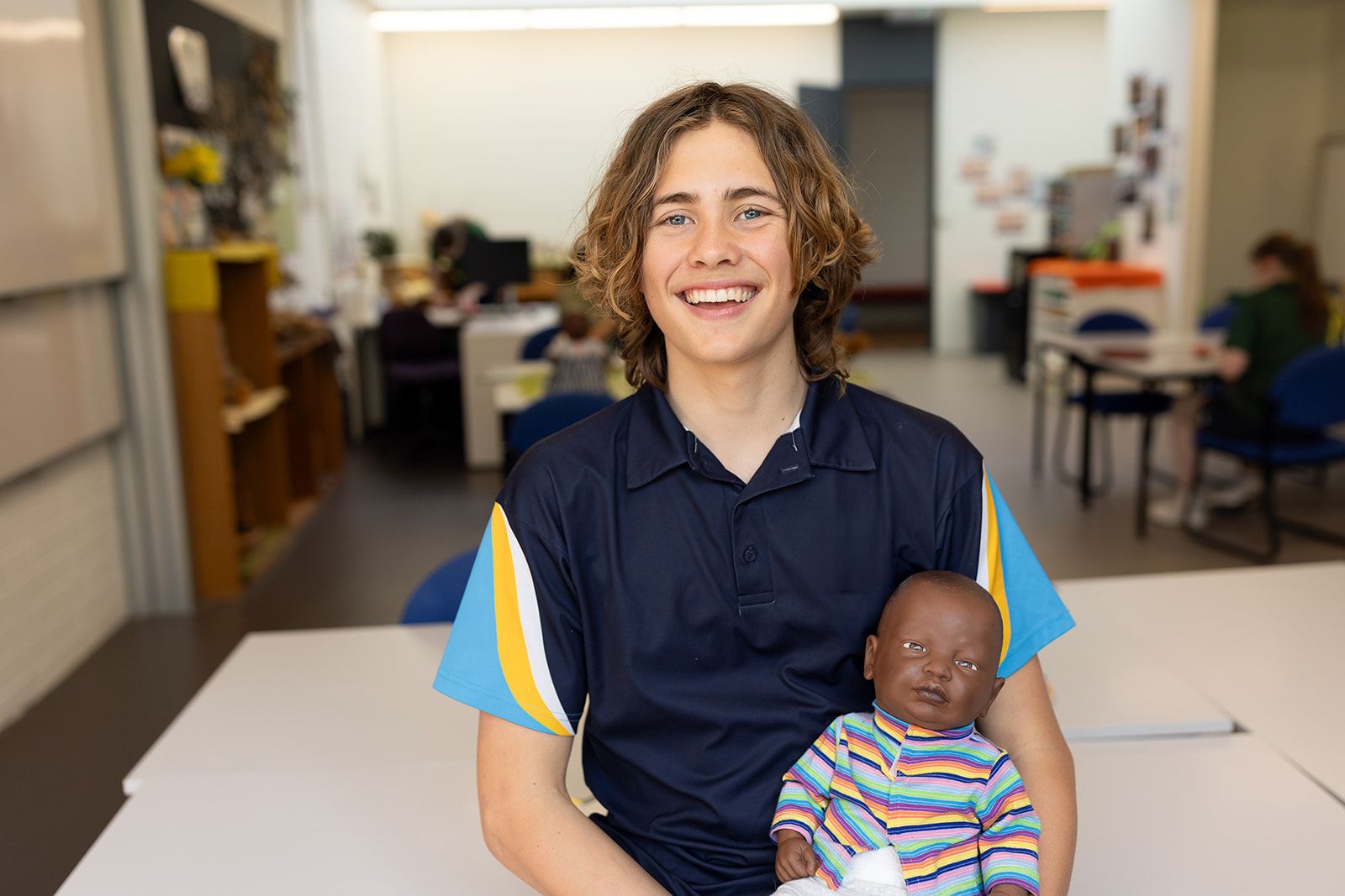 Student sitting with baby doll