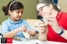 Teacher and student looking at animal jaws