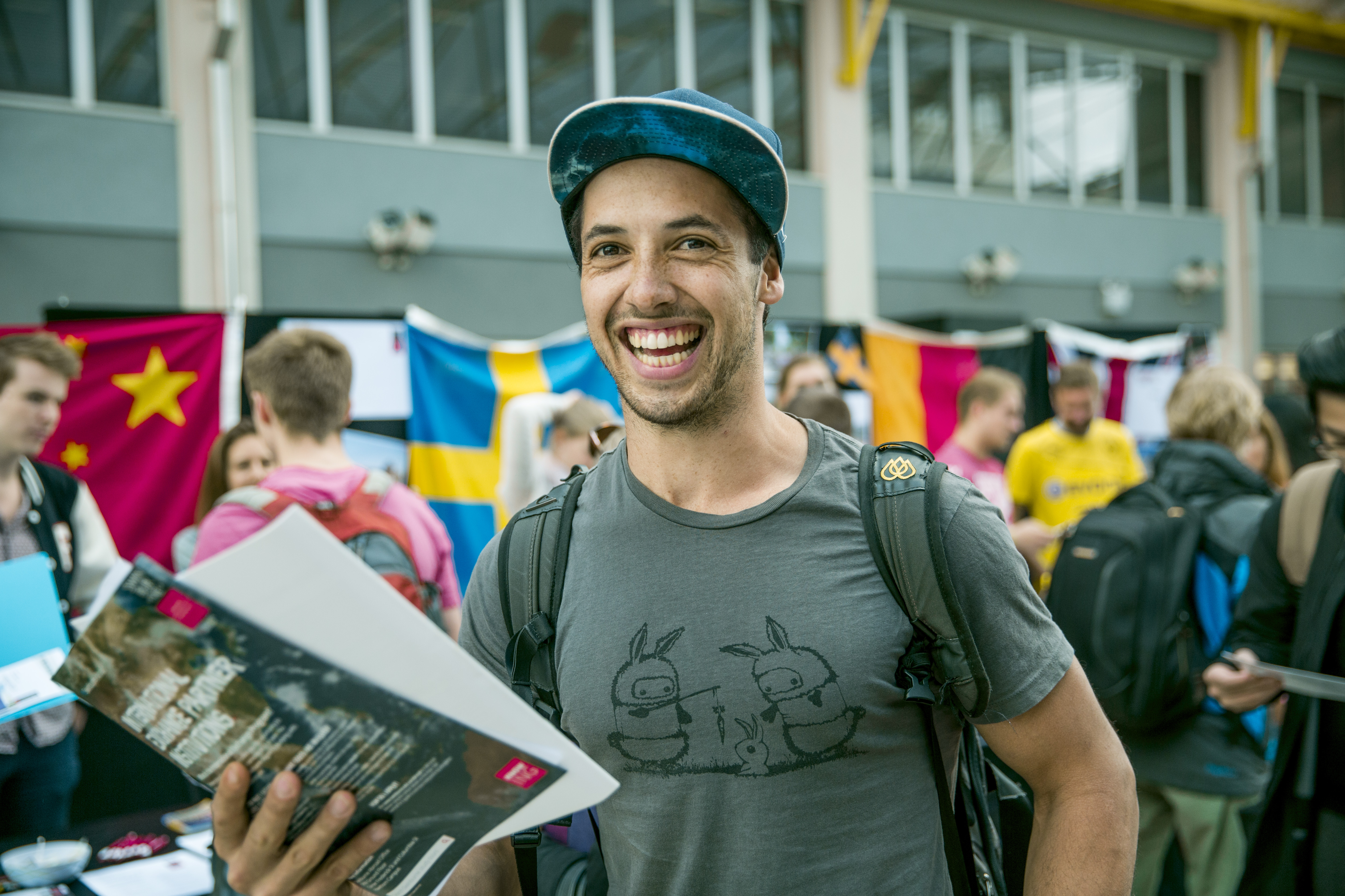 Student with brochures at the study abroad expo