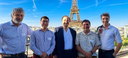 Five people posing together with the Eiffel Tower in Paris