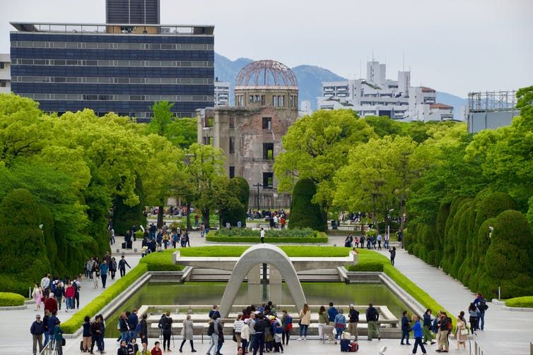 View of a crowded plaza with a fountain in Hiroshima