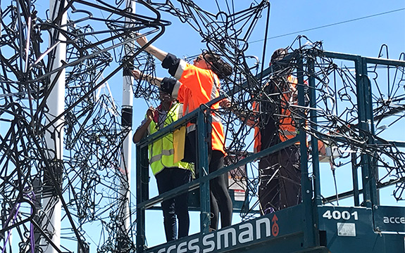 students installing the coat hanger array at FESTA 2018 in Christchurch