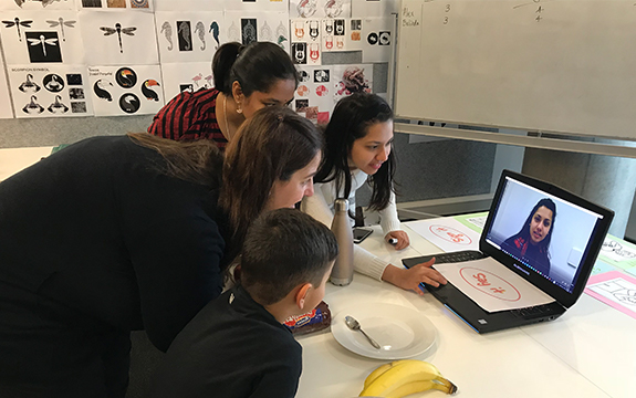 students with parent and child working on ideas for the app