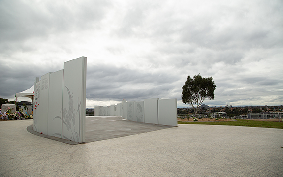 Melbourne’s Korean War Memorial panels with images of Australian soldiers, text and floral emblems
