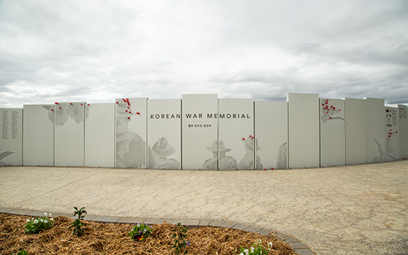 Melbourne’s Korean War Memorial panels with images of Australian soldiers, text and floral emblems