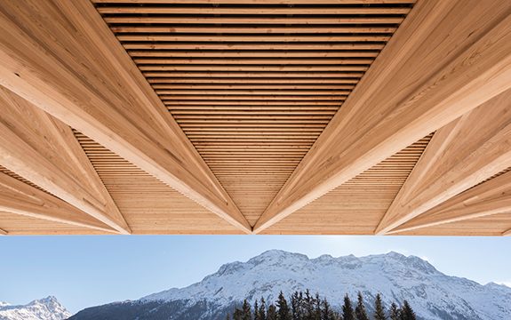The Kulm Eispavillion project has a cantilevered canopy made from horizontal wooden slats. 