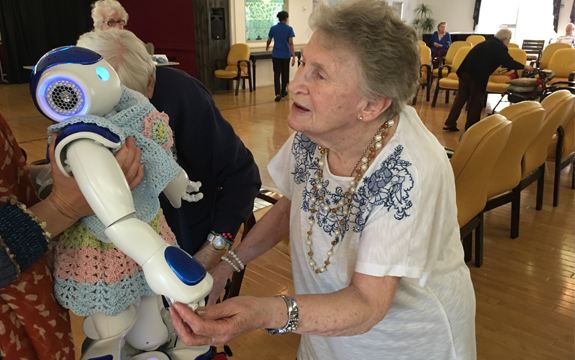 A person in an aged care home interacts with a NAO robot