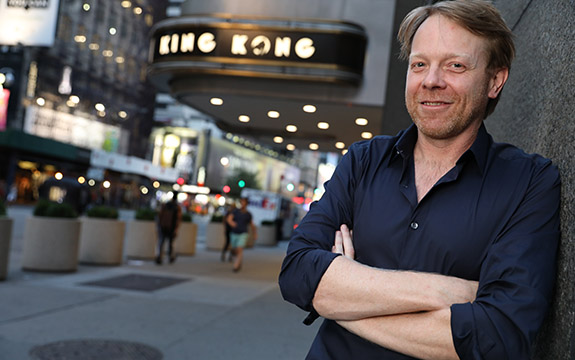 Sonny Tilders at Broadway in front of King Kong sign. 