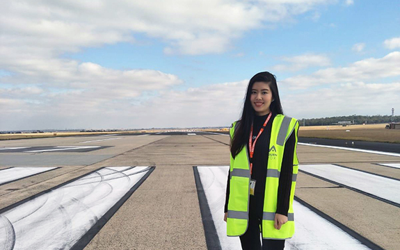 Swinburne aviation student Natalie Ng standing on the tarmac at Tullamarine airport
