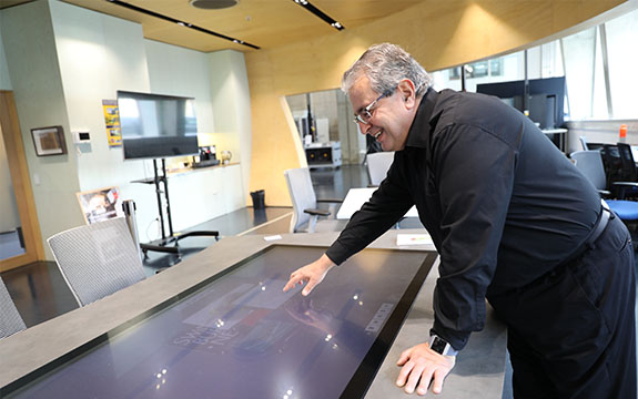Professor Dimitrios is in the Factory of the Future at Swinburne University of Technology using an interactive touch screen