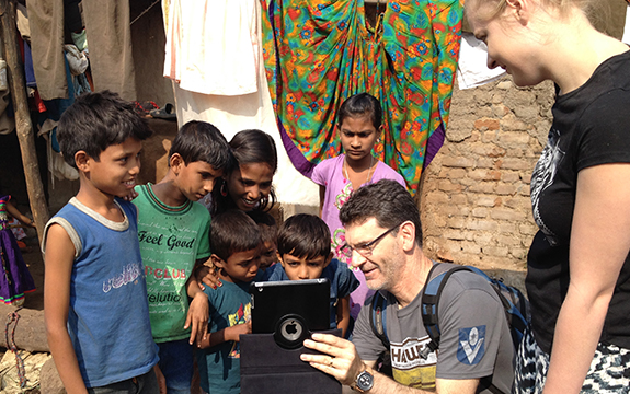Dr Jason Sargent with school kids in India