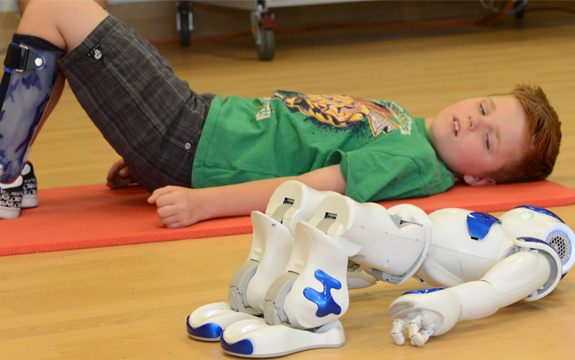 NAO robot showing nine year old Miles an exercise
