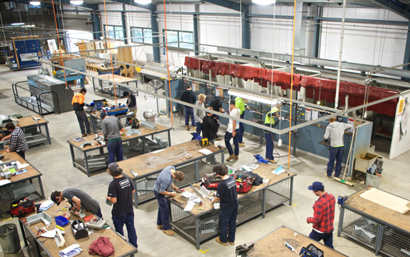 An aerial shot of trades students at work in the plumbing barn at the hawthorn campus