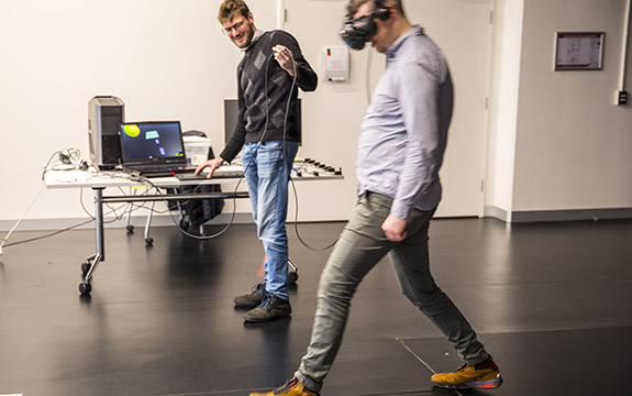 Two people using a VR headset and program. 