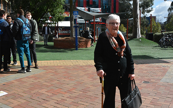 85 year old Anne Scott is standing out in the sunshine at the Swinburne campus.