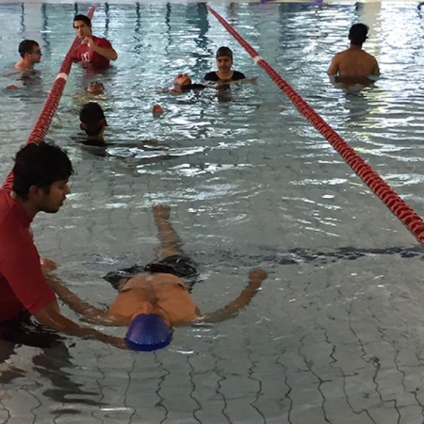 Swinburne student Praveen Kumar conducting swimming lessons as part of International Learn to Swim (ILTS) program