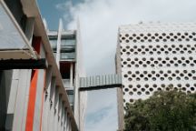 Shot of the ACMD and ATC building bridge at the Hawthorn campus, looking up above against a cloudy sky. 