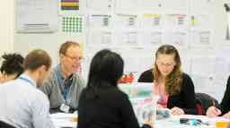 People doing work together on a desk