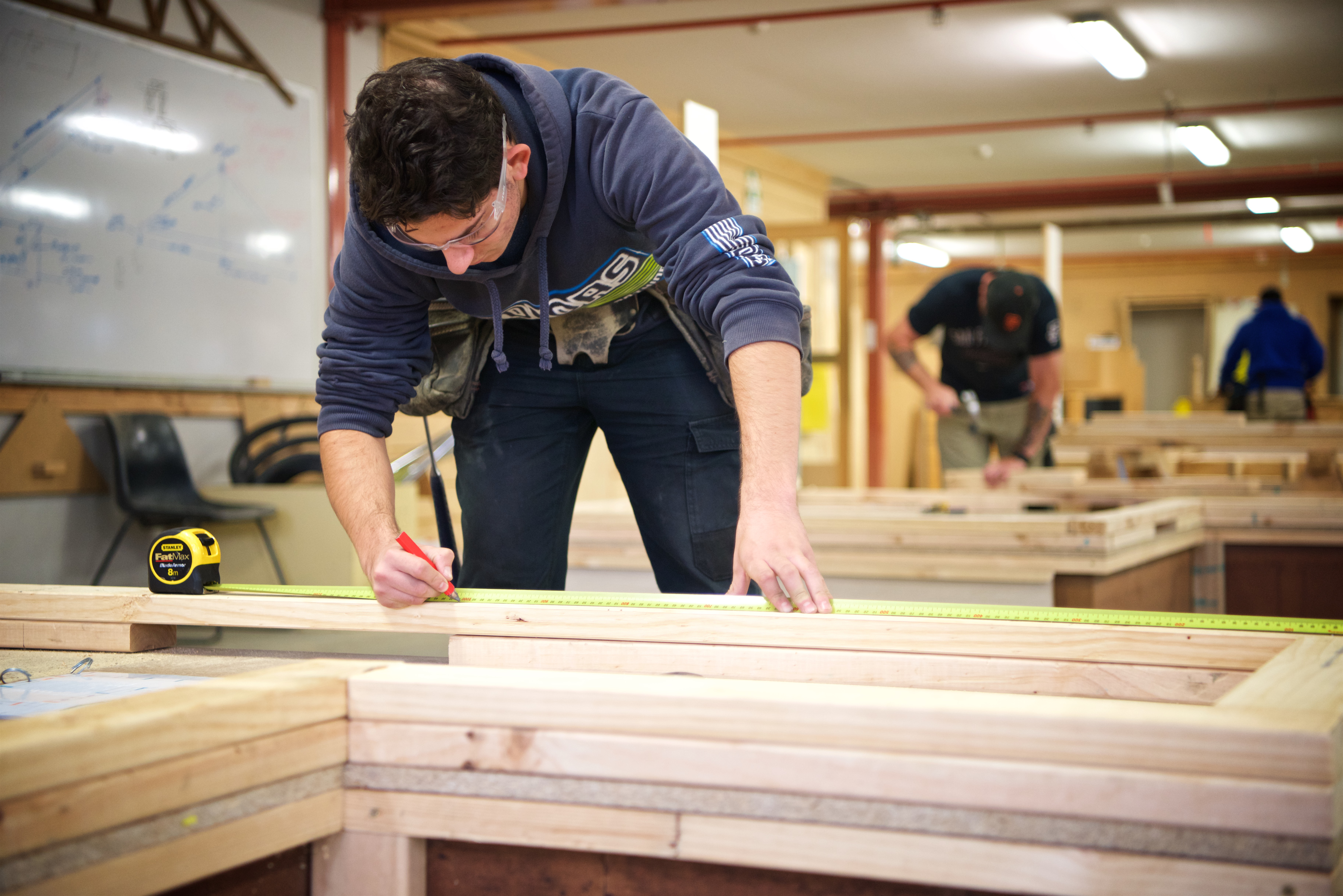 Construction students working on a piece of timber at the Croydon campus