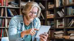 Student reading an e-book in a library