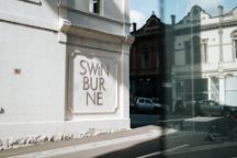 Swinburne wording on a white wall which surrounds part of the AMDC building.