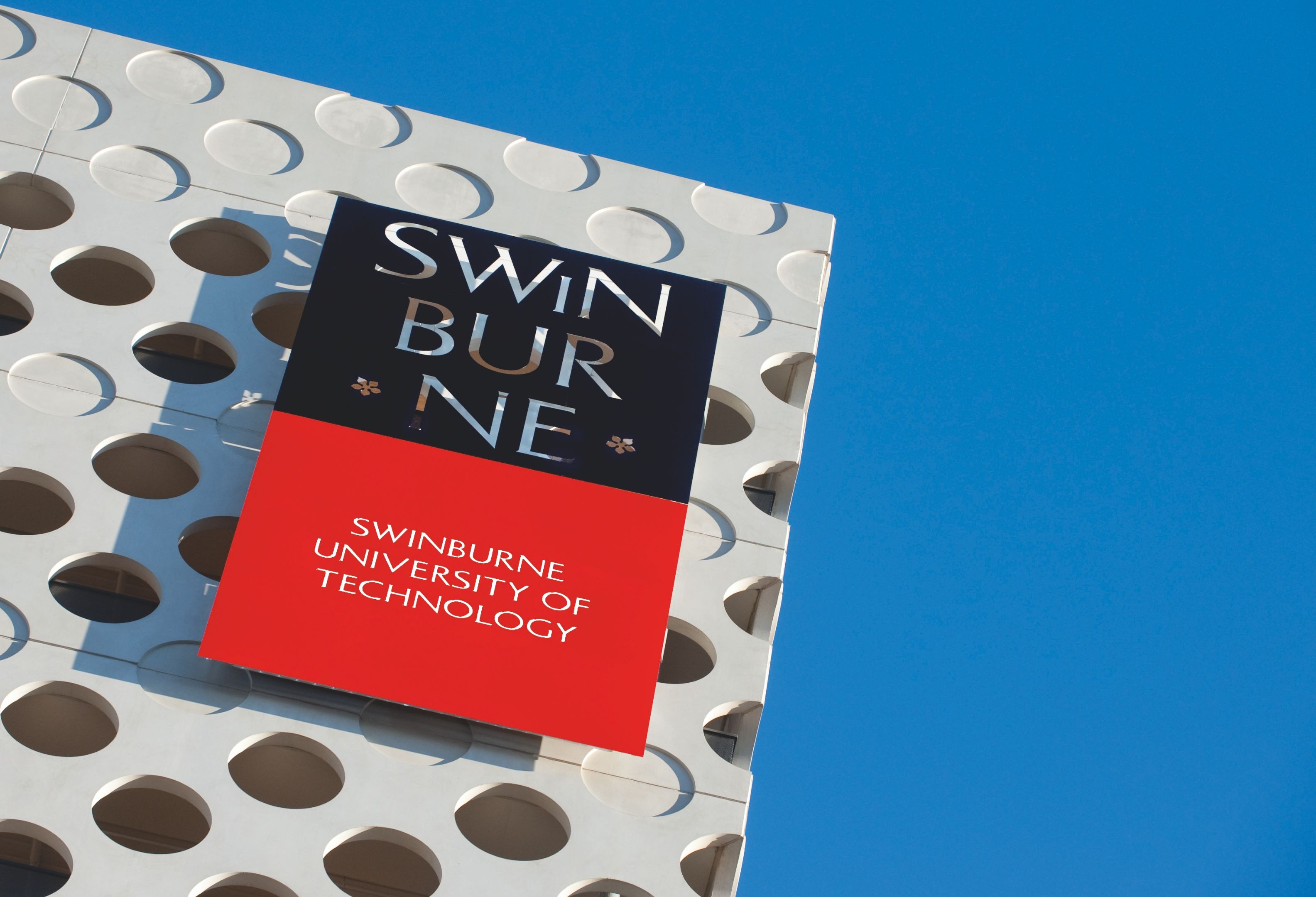 Swinburne logo on modern campus building 