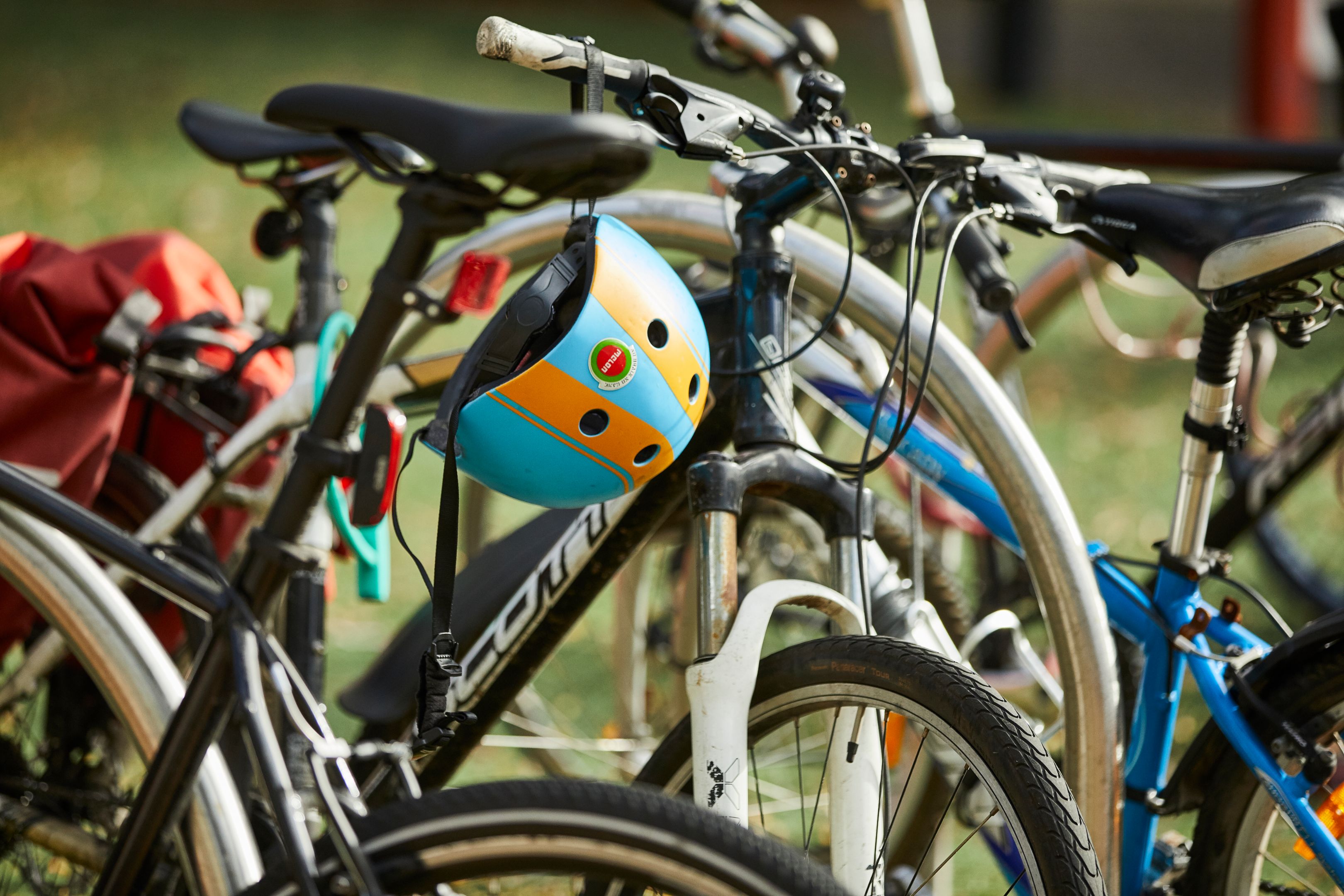 Multiple bicycles parked on Wakefield Street with a colourful bike helmet 